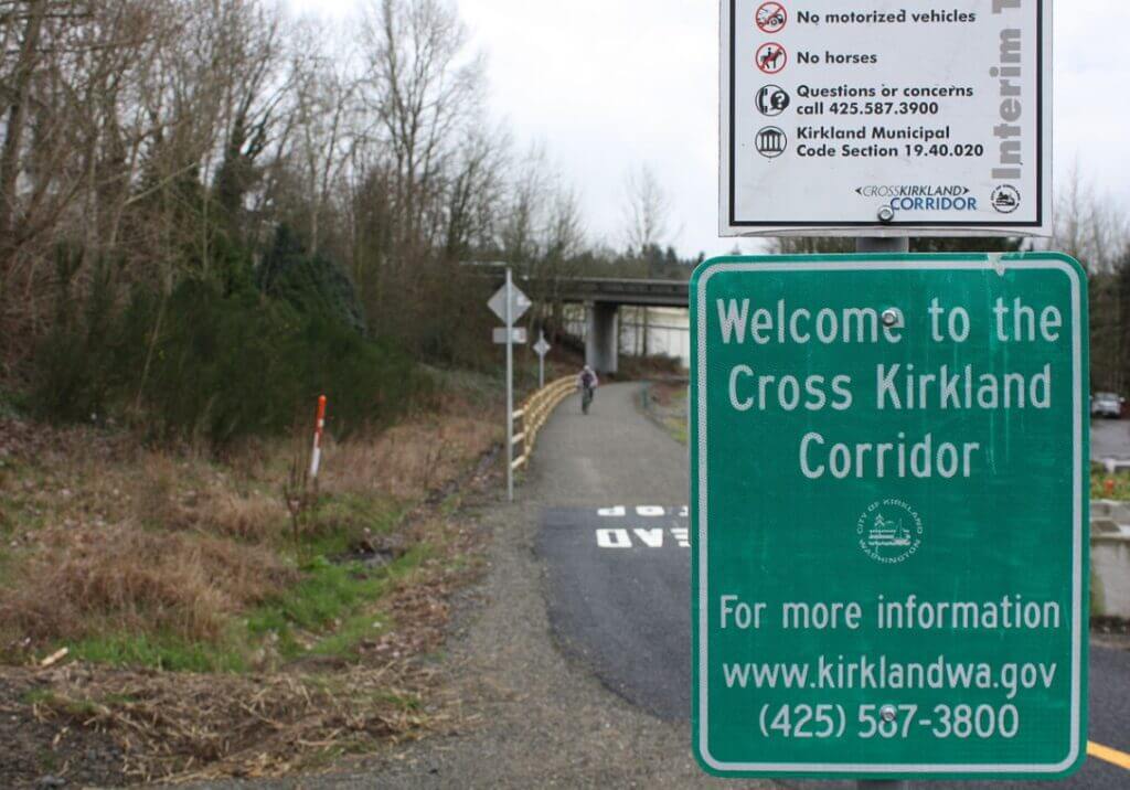Cross Kirkland Corridor / Wikipedia / Happybluemo
Link: https://en.wikipedia.org/wiki/Eastside_Rail_Corridor#/media/File:Cross_Kirkland_Corridor_sign_2015.JPG